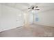 Bright and spacious empty bedroom with neutral carpet, and a ceiling fan at 5113 Saddleback Dr, Mount Holly, NC 28120