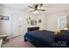 Bright bedroom featuring plush carpet, ceiling fan, and ample closet space for comfortable living at 5113 Saddleback Dr, Mount Holly, NC 28120