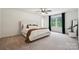 Bright bedroom with a large window, neutral carpet, a ceiling fan, and a king bed at 5113 Saddleback Dr, Mount Holly, NC 28120