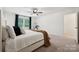 Bright bedroom with a large window, neutral carpet, and a king bed with brown and white decor at 5113 Saddleback Dr, Mount Holly, NC 28120