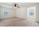 Bright and spacious empty bedroom with neutral carpet, and a ceiling fan at 5113 Saddleback Dr, Mount Holly, NC 28120