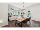 Dining area with backyard access, modern chandelier and furniture, with an open view into the living room at 5113 Saddleback Dr, Mount Holly, NC 28120