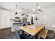 Eat-in kitchen featuring stainless steel appliances, granite countertops, pendant lighting, and a modern table at 5113 Saddleback Dr, Mount Holly, NC 28120