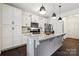 Beautiful kitchen with white cabinets, stainless steel appliances, granite countertops, and modern pendant lighting at 5113 Saddleback Dr, Mount Holly, NC 28120