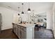 Open concept kitchen with an island, stainless appliances, view to dining area and living room at 5113 Saddleback Dr, Mount Holly, NC 28120