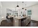 Open kitchen with stainless appliances, an island and a seamless view to the dining area and living room at 5113 Saddleback Dr, Mount Holly, NC 28120