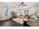 Bright living room featuring hardwood floors, white walls, a ceiling fan, and lots of natural light at 5113 Saddleback Dr, Mount Holly, NC 28120