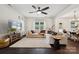 Bright and airy living room featuring hardwood floors, white walls, a ceiling fan, and lots of natural light at 5113 Saddleback Dr, Mount Holly, NC 28120