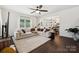 Bright living room with a ceiling fan and an open floor plan to the kitchen and dining area, perfect for entertaining at 5113 Saddleback Dr, Mount Holly, NC 28120