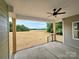 Covered back porch with a ceiling fan offers a relaxing view of the open backyard at 5408 Unionville Brief Rd, Unionville, NC 28110