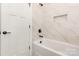 Bright bathroom features a white tub with marble-look tile surround and modern matte black fixtures at 5408 Unionville Brief Rd, Unionville, NC 28110