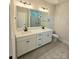Well-lit bathroom features a double vanity, modern fixtures, and a glass-enclosed shower at 5408 Unionville Brief Rd, Unionville, NC 28110