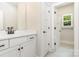 Clean bathroom with black accents, white vanity with sink, and a view to the adjacent room at 5408 Unionville Brief Rd, Unionville, NC 28110