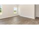 Spacious bedroom with hardwood floors, neutral walls, and plenty of natural light from the windows at 5408 Unionville Brief Rd, Unionville, NC 28110