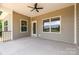 Spacious covered patio area features a ceiling fan, concrete floor, and views of the surrounding landscape at 5408 Unionville Brief Rd, Unionville, NC 28110