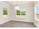Sunlit dining room featuring wood-look floors and views of the outdoors through large windows at 5408 Unionville Brief Rd, Unionville, NC 28110