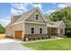 Charming home with attached garage, stone accents, manicured lawn, and fresh landscaping at 5408 Unionville Brief Rd, Unionville, NC 28110