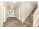 Welcoming foyer featuring wood-look flooring, a staircase, and views of the front door at 5408 Unionville Brief Rd, Unionville, NC 28110