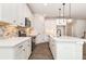 Well-appointed kitchen featuring white cabinets, a center island, and stainless steel appliances at 5408 Unionville Brief Rd, Unionville, NC 28110