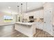 Bright and airy kitchen with white cabinets, stainless steel appliances, and a spacious center island at 5408 Unionville Brief Rd, Unionville, NC 28110