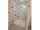 Modern shower features glass doors, black hardware, and pristine white marble tile at 5408 Unionville Brief Rd, Unionville, NC 28110