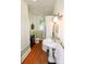 Bathroom featuring a classic sink, vintage fixtures, and wooden floors at 616 N Deal Ave, Newton, NC 28658