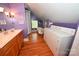 Bathroom with a freestanding tub, walk-in shower, a double vanity and a washer/dryer at 616 N Deal Ave, Newton, NC 28658