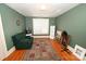 Bedroom showing a comfortable green chair, a rug, and hardwood floors at 616 N Deal Ave, Newton, NC 28658