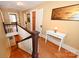 Upstairs hallway with wooden floors, staircase, and natural light at 616 N Deal Ave, Newton, NC 28658