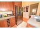 Spacious kitchen featuring stainless steel refrigerator, wooden cabinetry, and tile countertops at 616 N Deal Ave, Newton, NC 28658