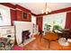 Living room featuring brick fireplace, hardwood floors, and picture windows for a sun-filled space at 616 N Deal Ave, Newton, NC 28658