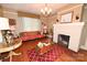 Charming living room with a brick fireplace, hardwood floors, and large windows providing ample natural light at 616 N Deal Ave, Newton, NC 28658