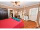 Comfortable main bedroom with a four-poster bed, wood floors, and natural light at 616 N Deal Ave, Newton, NC 28658