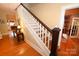 Traditional staircase with wooden steps and white railings, leading to an upstairs hallway at 616 N Deal Ave, Newton, NC 28658
