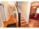 Traditional staircase with wooden steps and white railings, leading to an upstairs hallway at 616 N Deal Ave, Newton, NC 28658