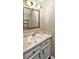 Bathroom featuring a vanity with a decorative countertop, large mirror, and white cabinetry at 6401 Windsor Gate Ln, Charlotte, NC 28215