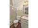 Bathroom features a shower stall with glass door, single sink vanity with mirror, and a toilet at 6401 Windsor Gate Ln, Charlotte, NC 28215