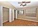 Spacious bedroom featuring wood floors, ample closet space, and a bright window at 6401 Windsor Gate Ln, Charlotte, NC 28215