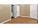Spacious room with wood-look floors and multiple doors, offering versatility and easy access at 6401 Windsor Gate Ln, Charlotte, NC 28215