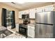 Well-lit kitchen featuring stainless steel appliances, granite countertops, and white cabinetry at 6401 Windsor Gate Ln, Charlotte, NC 28215