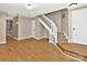 Open living space with wood floors, a staircase, and neutral paint, creating a welcoming atmosphere at 6401 Windsor Gate Ln, Charlotte, NC 28215