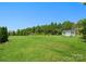 Expansive backyard featuring a storage shed, lush green lawn, and mature trees at 6535 Bridgemoor Dr, Indian Trail, NC 28079