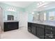Spacious primary bathroom featuring separate vanities with granite countertops, and a glass shower at 6535 Bridgemoor Dr, Indian Trail, NC 28079