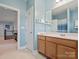 Bright, blue bathroom with single vanity, large mirror and open doorway to the upstairs hallway at 6535 Bridgemoor Dr, Indian Trail, NC 28079