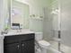 Bathroom featuring a shower and sleek vanity with quartz countertops and a decorative shelf at 6535 Bridgemoor Dr, Indian Trail, NC 28079