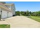 Wide driveway leading to a three-car garage, complemented by a basketball hoop and green yard at 6535 Bridgemoor Dr, Indian Trail, NC 28079