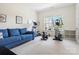 Well-lit exercise room with a blue sofa and fitness equipment at 6535 Bridgemoor Dr, Indian Trail, NC 28079
