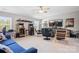 Large, brightly lit gameroom with arcade games, blue sofa, and TV with comfortable seating at 6535 Bridgemoor Dr, Indian Trail, NC 28079