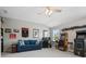 Spacious game room with a vaulted ceiling, a ceiling fan, blue sofa and two arcade game machines at 6535 Bridgemoor Dr, Indian Trail, NC 28079