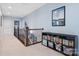 Bright upstairs hallway with iron railing, art and a bookcase for storage at 6535 Bridgemoor Dr, Indian Trail, NC 28079